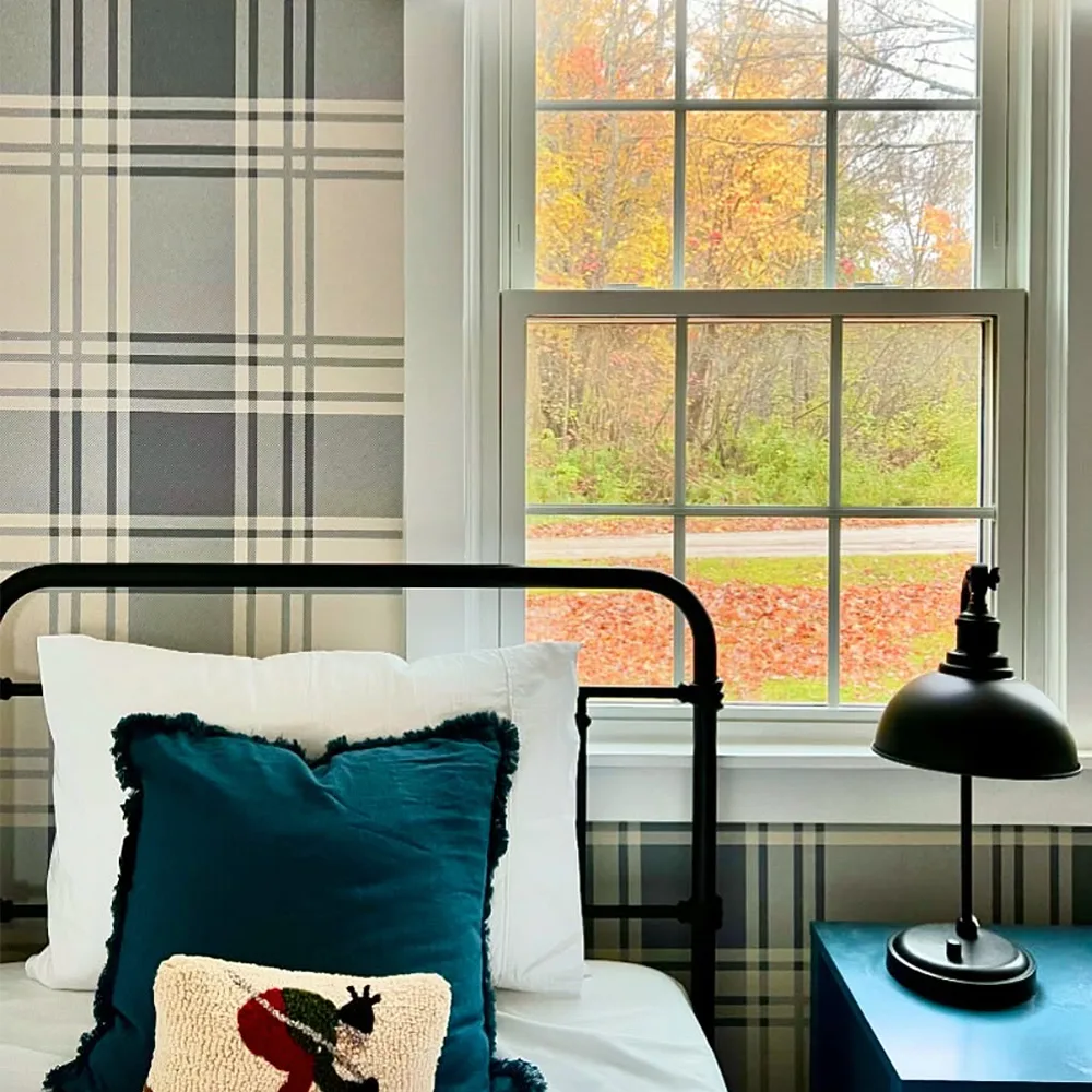 Plaid wallpaper in a cabin bedroom.