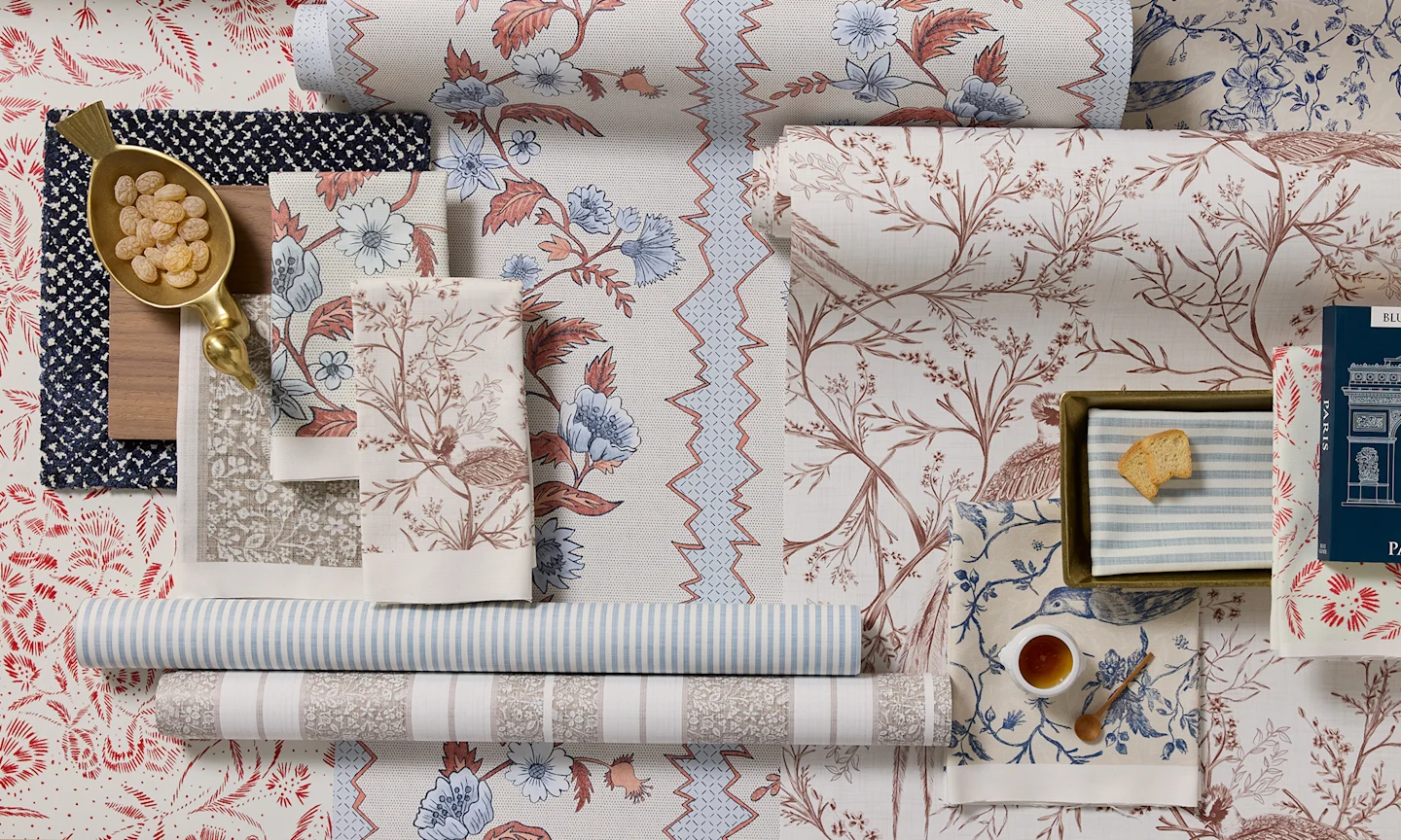 French country wallpaper rolls and fabric swatches.