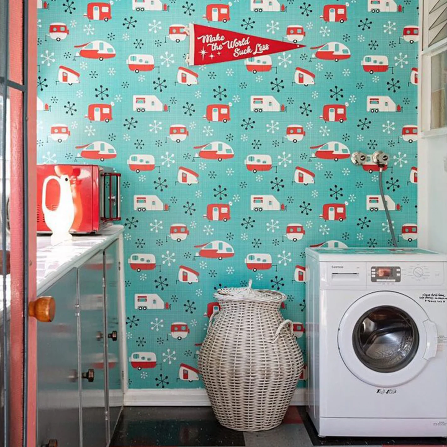 Vintage camper themed wallpaper in a laundry room.