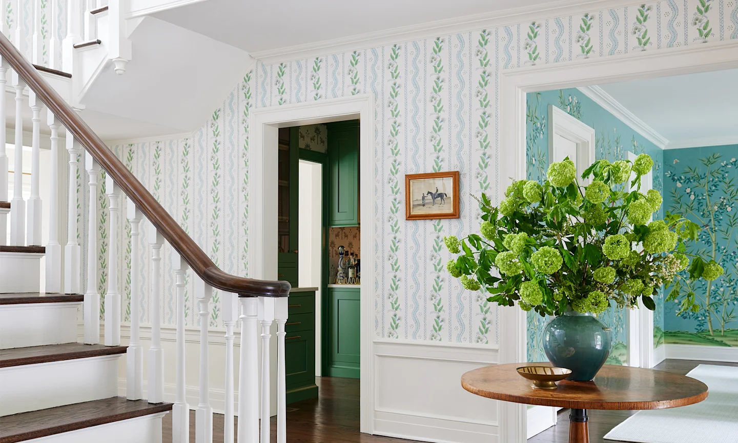 Foyer with floral stripe wallpaper.