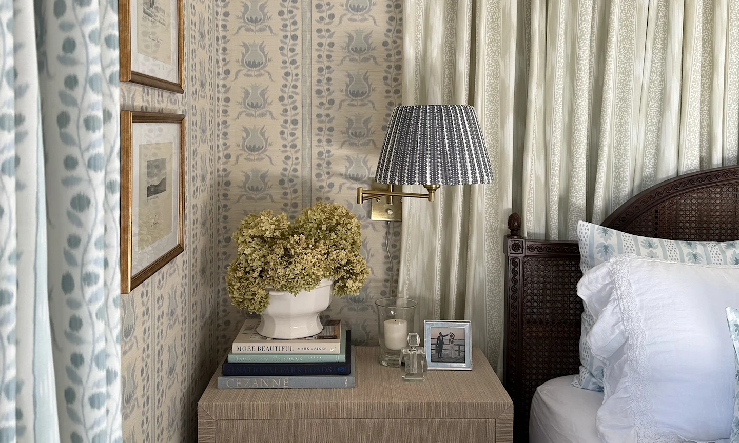 Bedroom with ikat pomegranates wallpaper and coordinating curtains, fabric accents and bedding.