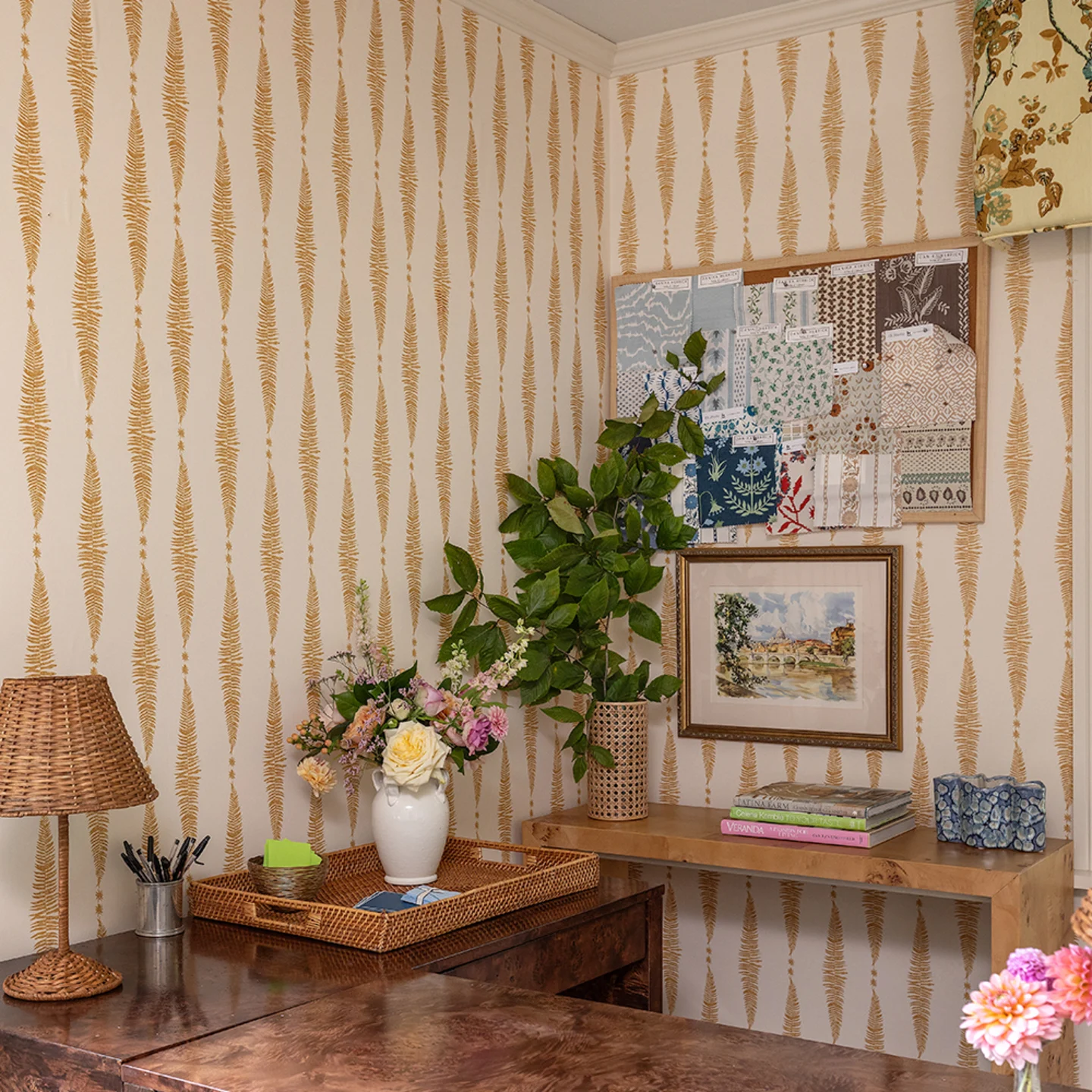 Gold fern leaf on cream vertical stripe wallpaper in a home office.