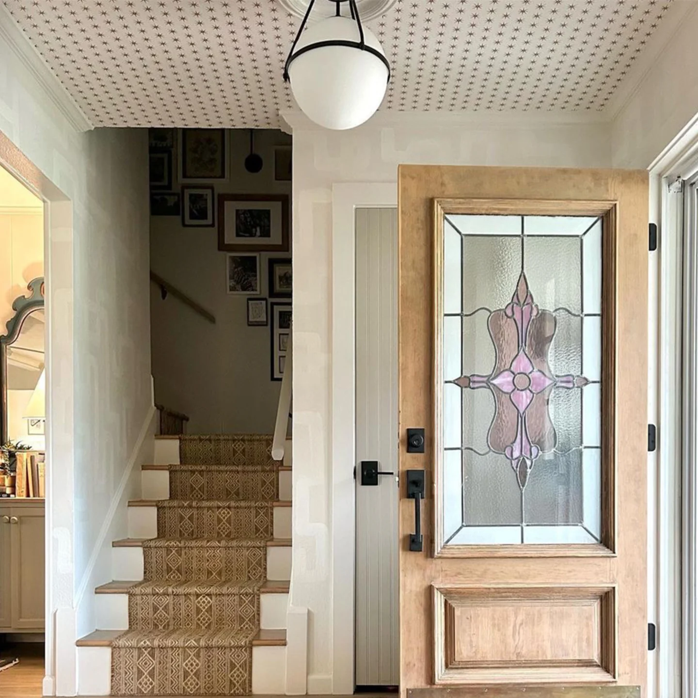 Entryway with star wallpaper on the ceiling.
