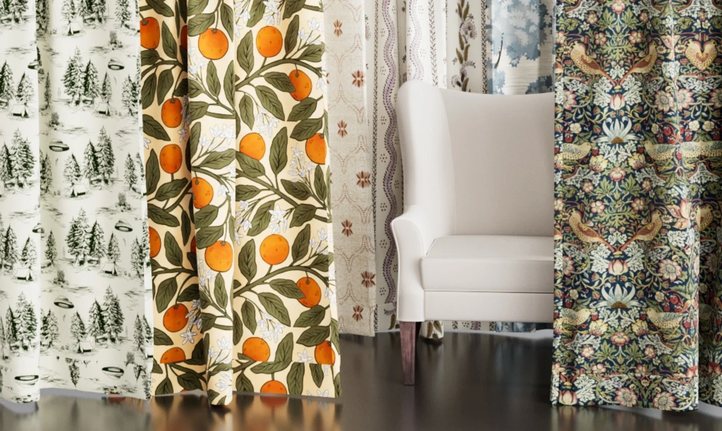 Multiple colorful curtains hanging around a chair with throw pillows