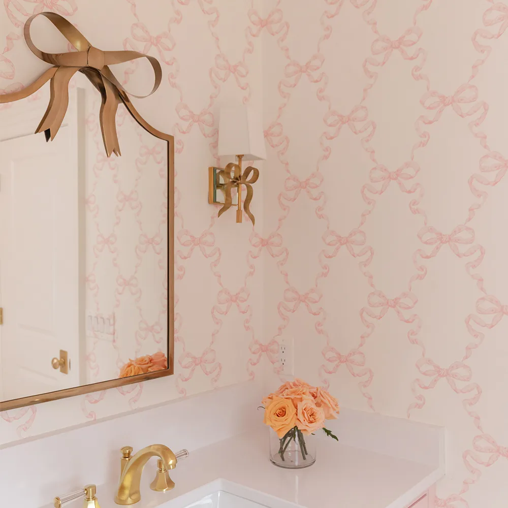Bathroom with pink bow trellis design wallpaper.