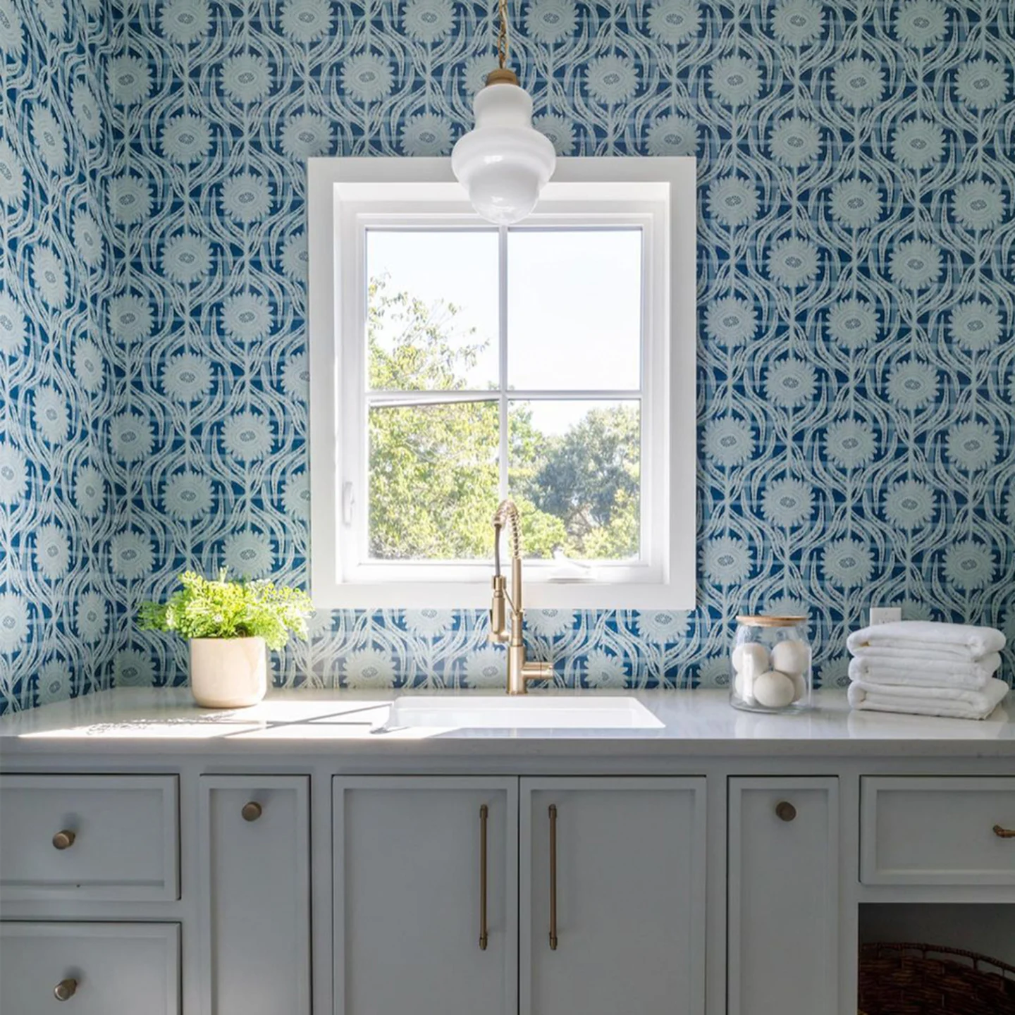 Laundry room sink with blur floral plaid wallpaper