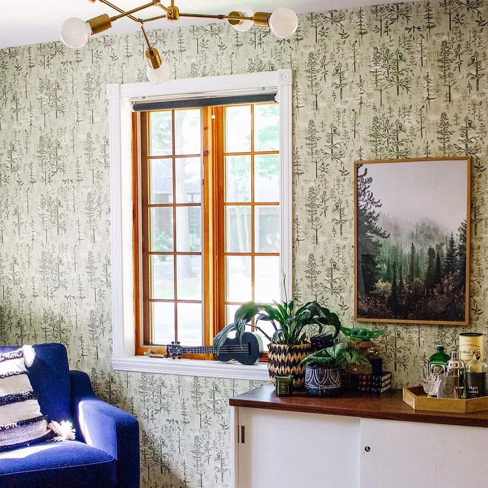 Boreal forest inspired wallpaper in a living space.