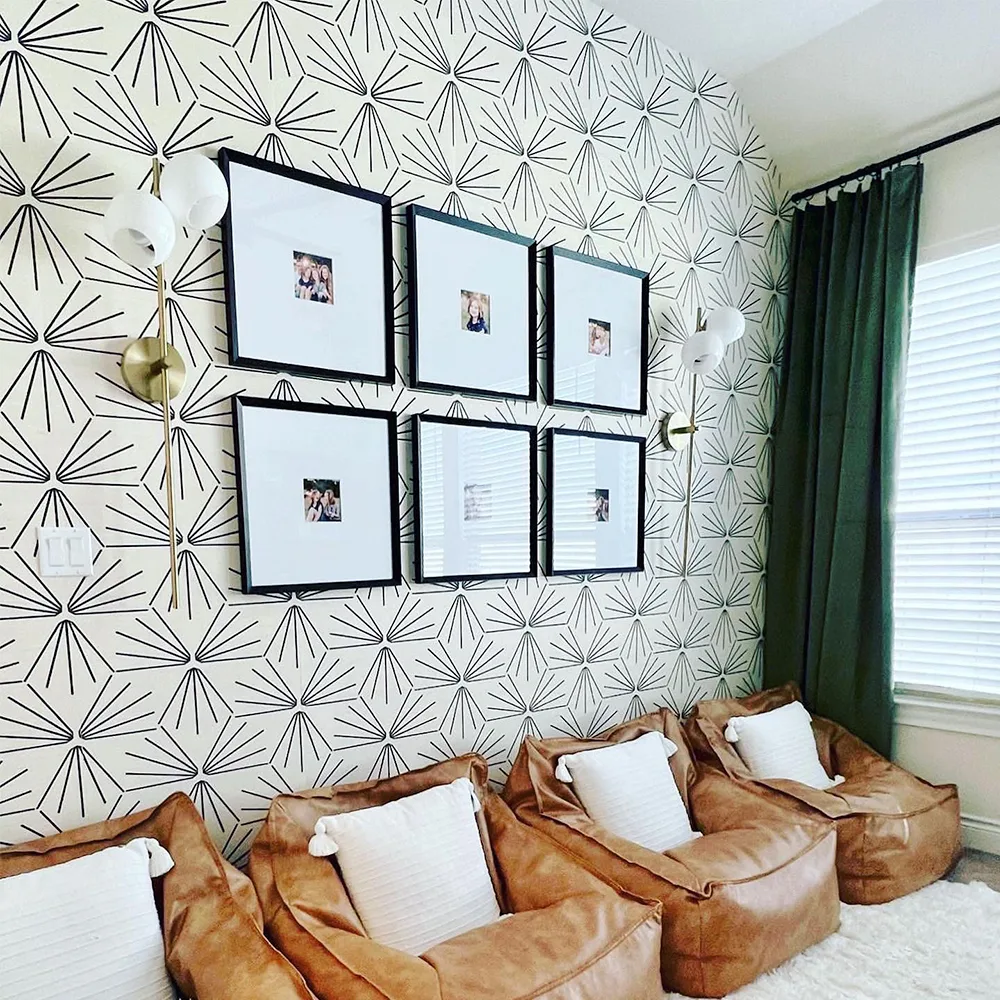 Black and white sun tile wallpaper in a living space.