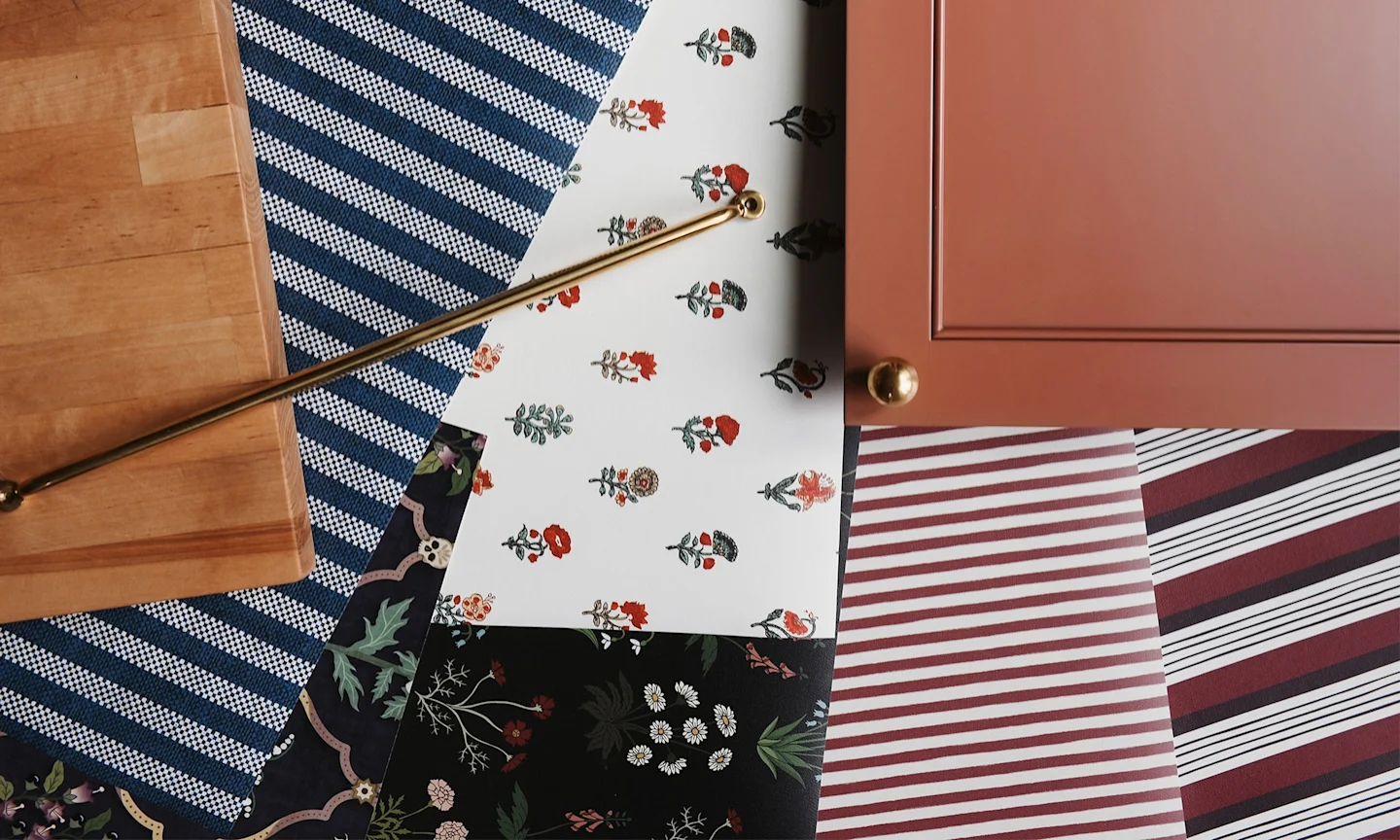 Wallpaper samples along slide cabinet and countertops