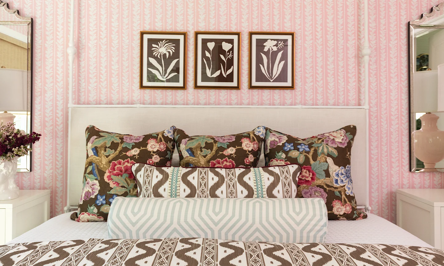 A beautiful bedroom with coordinating brown and pink striped and floral bedding