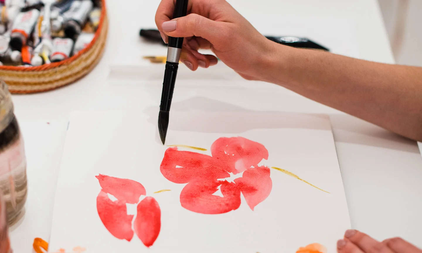Artist creating a watercolor floral design